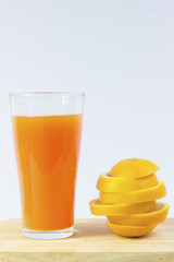 Orange juice and slices of orange on white