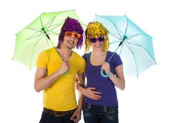 Couple with wigs, sunglasses and umbrellas