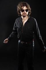 Fototapeta na wymiar Cool rock style dancing musician with long brown hair and beard.
