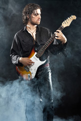 Fototapeta na wymiar Psychedelic rock guitarist with long brown hair and beard. Dress