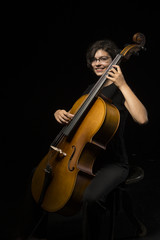 Fototapeta premium Young woman plays cello
