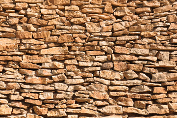 Fototapeta premium old wall made of big and little yellow stones