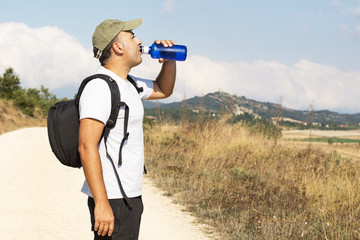 Hiker driking water from bottle.