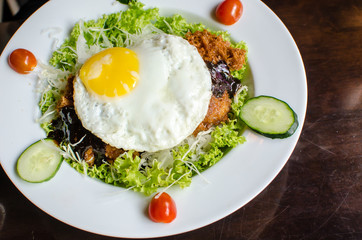Salad with egg on top