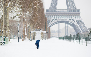 Winter in Paris. Happy young girl jumping