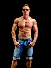 Fototapeta na wymiar Handsome young muscle man naked wearing jeans, sunglasses