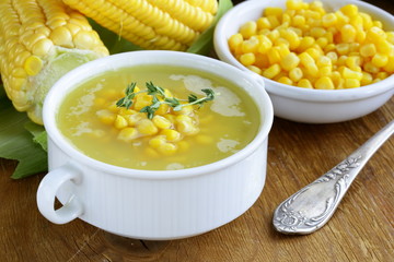 soup of fresh yellow corn served on a wooden table © Olga Kriger