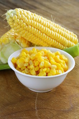 Canned corn in a bowl, and fresh cobs © Olga Kriger