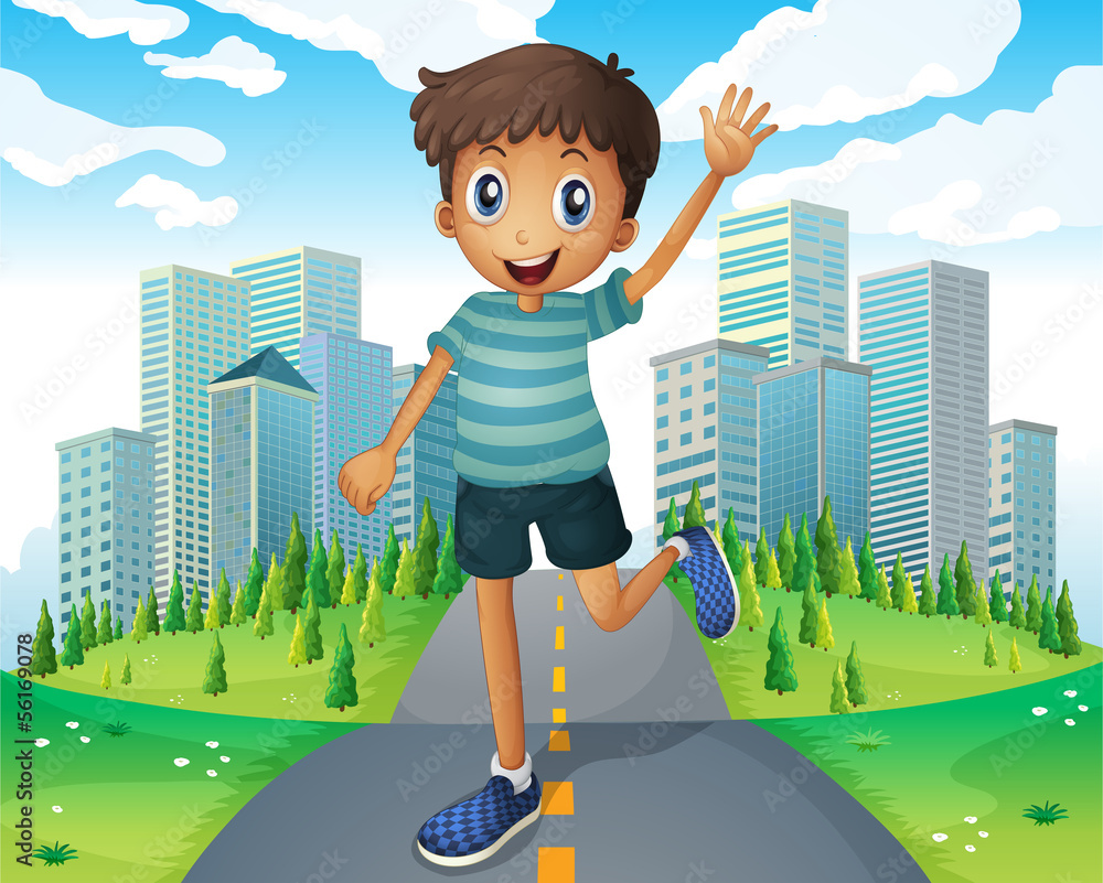 Wall mural A boy waving while running in the middle of the road