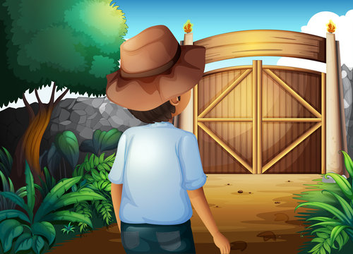 A man with a hat inside the gated yard