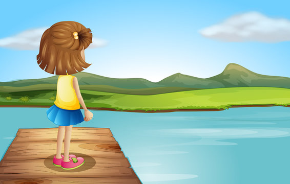 A little girl standing at the wooden port