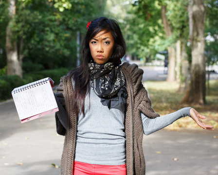 Dissapointed Asian Girl With Notepad