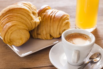 Breakfast with coffee and croissants of custard