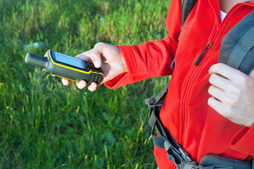 Hiker young woman holding in her hand GPS © lithiumphoto