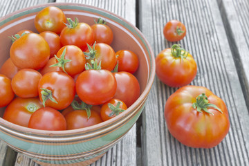 ripe tomatoes in a bowl on the table