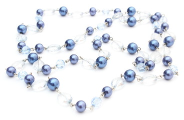 Blue, shiny necklace for the woman on white background