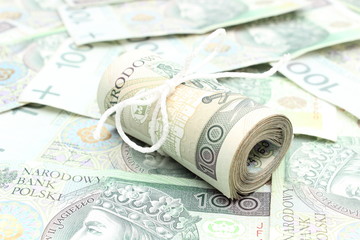 Closeup of roll of tied banknotes on money background