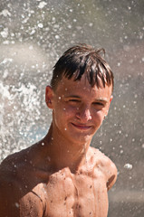 Teenager in a spray of water.