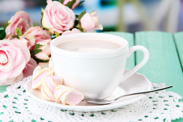 Cocoa drink on wooden  table, on bright background