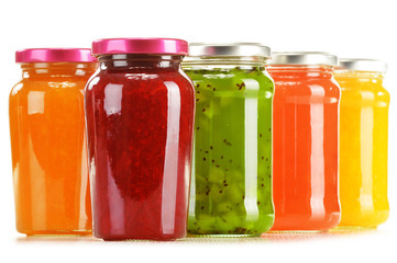 Jars of fruity jams isolated on white background