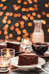 Chocolate cake with blurry christmas lights.