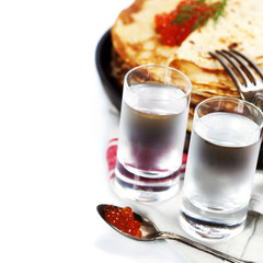 Russian vodka with pancakes and red caviar