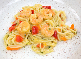 A close view of angel hair pasta with shrimp on a dish