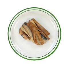 Smoked herring fillets on a green striped plate
