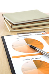 Graphs, charts, business report on table.