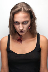 closeup of woman with a realistic bloody wound 