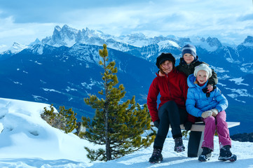 Fototapeta na wymiar Family walking on winter mountain slope