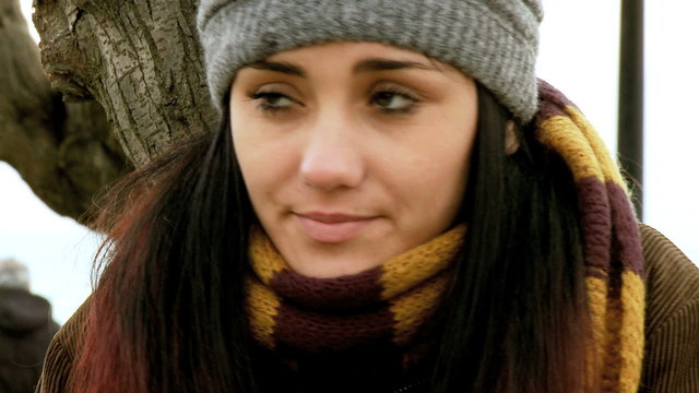 Young caucasian woman freezing in the winter with hat and scarf