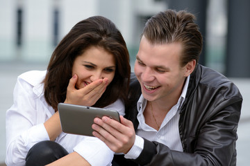 young couple using tablet