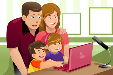 Happy family looking at a laptop