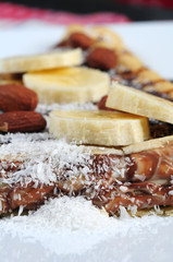 close up crepes with banana, chocolate sauce and almond