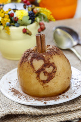 Baked apple decorated with cinnamon heart shape ornament
