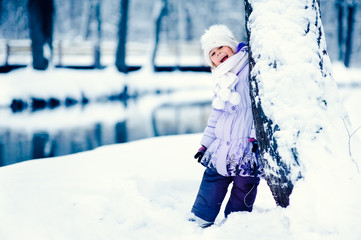 happy girl has a fun in winter park