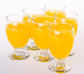 Fruit drink in glasses on white