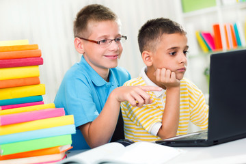 two young boys looking at the laptop