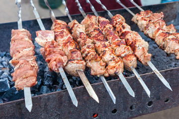 Juicy slices of meat with sauce prepare on coals