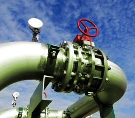 Industrial zone, Steel pipelines and valves against blue sky