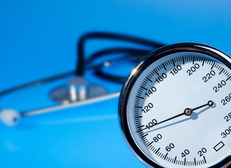 Stethoscope and sphygmomanometer on blue background