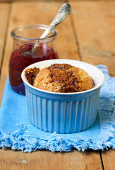 Cake in blue ramekin and jam in jar