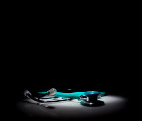 Stethoscope in a spotlight on black background