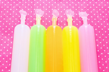 Colorful ice candies on a background of polka dots