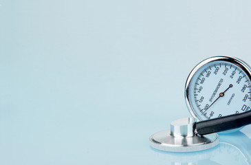 Stethoscope and sphygmomanometer on blue background