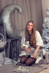 Girl surrounded by Christmas paraphernalia