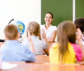 Fototapeta premium School children in classroom at lesson