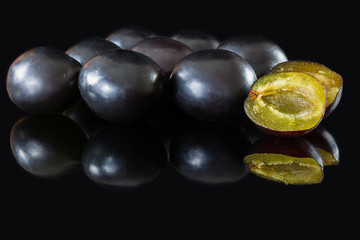 plums on a black glass