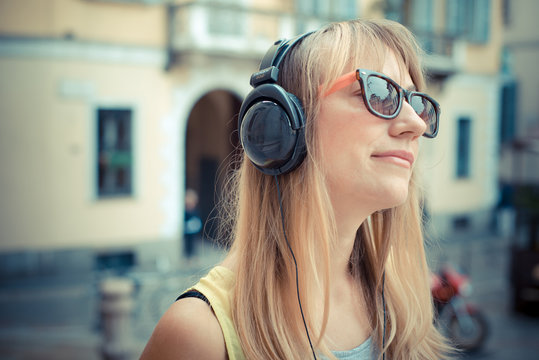 beautiful blonde woman listening to music